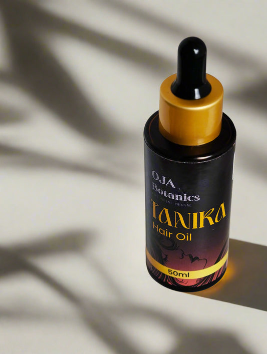 Bottle of Tanika Hair Oil by OJA Botanics with golden cap.