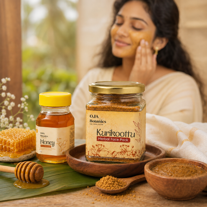 Woman applying a herbal face pack with jars of honey and Kurikooftu face pack on a wooden surface.