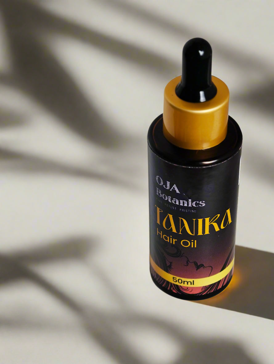 Bottle of Tanika Hair Oil by OJA Botanics with golden cap.